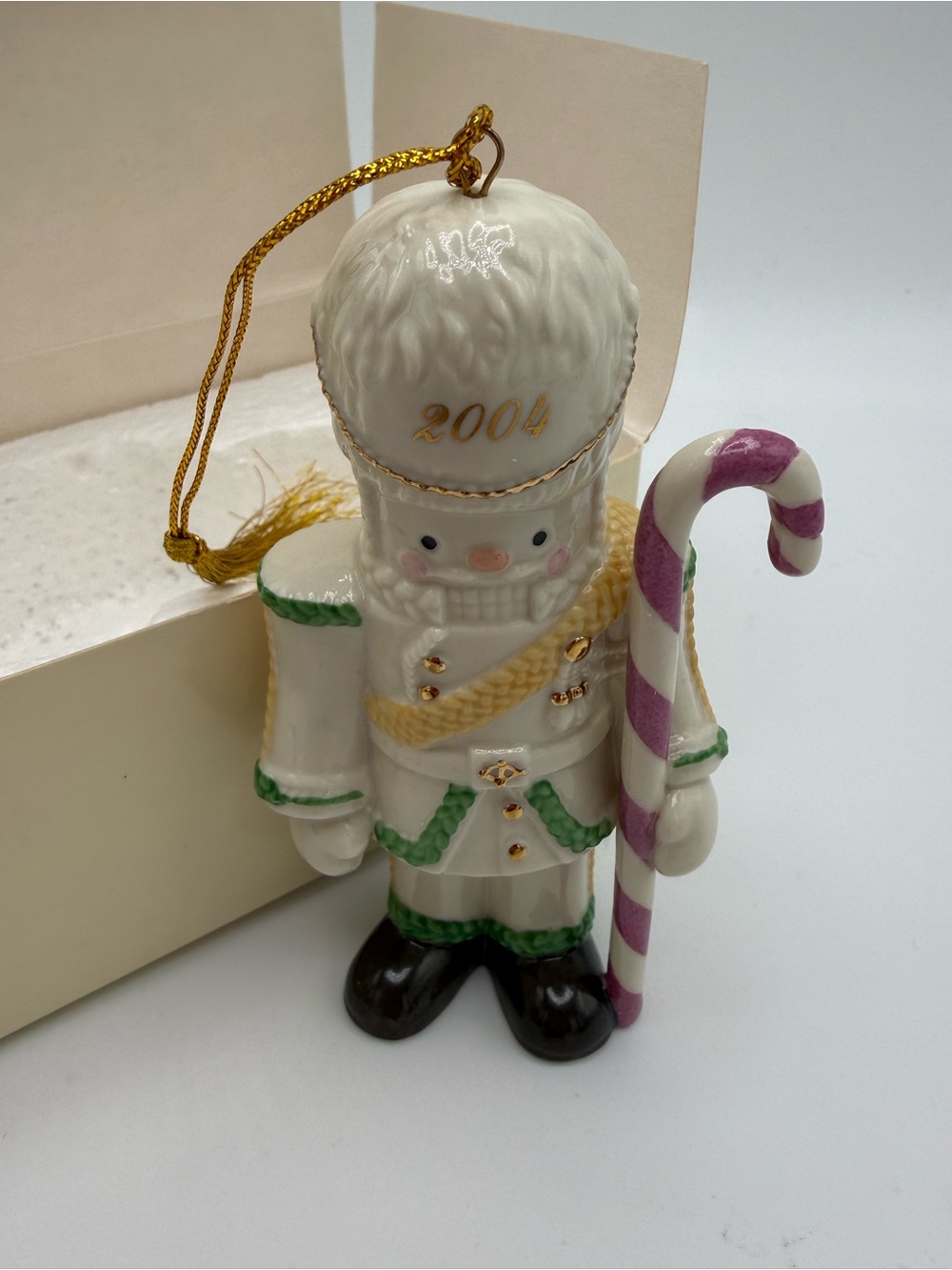 2004-Lenox White Nutcracker Ornament with Pink Candy Cane and Gold Accents